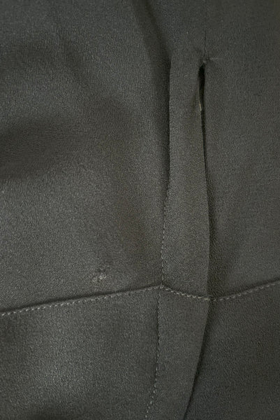 Side detail view of 1930s vintage black rayon crepe evening gown with statement sleeves beaded with glass beads and brass sequins, small to medium. Showing a snag in the fabric by the zipper.