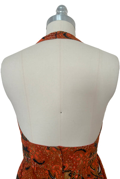 Bodice back view of 1970s vintage orange and black Halloween bat and spider wax print cotton maxi dress with halter neckline, extra small to small.