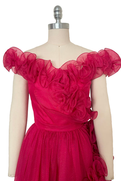 Bodice front view of 1960s vintage hot pink iridescent glitter organza ruffled evening dress by Mike Benet, size extra extra small to extra small. Showing the off the shoulder ruffled neckline and wrapped bodice.