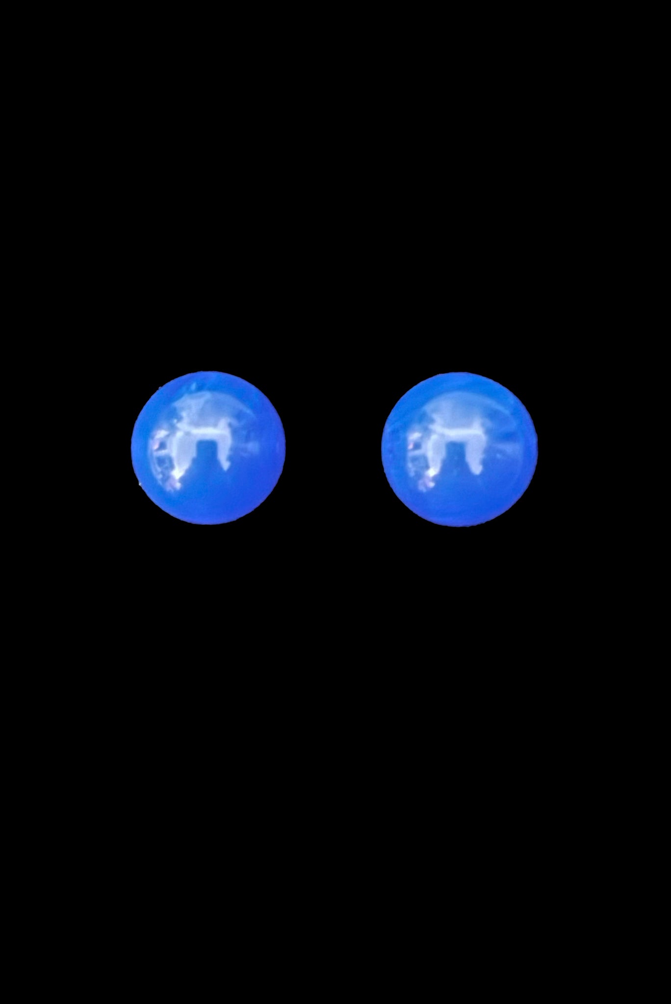 Vertical front view of 1980s vintage bright blue Lucite gumball stud pierced earrings.