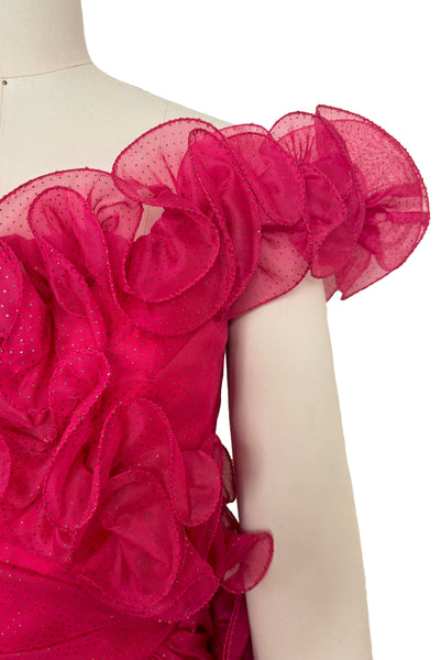 Detail view of 1960s vintage hot pink iridescent glitter organza ruffled evening dress by Mike Benet, size extra extra small to extra small. Showing the off the shoulder ruffled neckline and wrapped bodice.