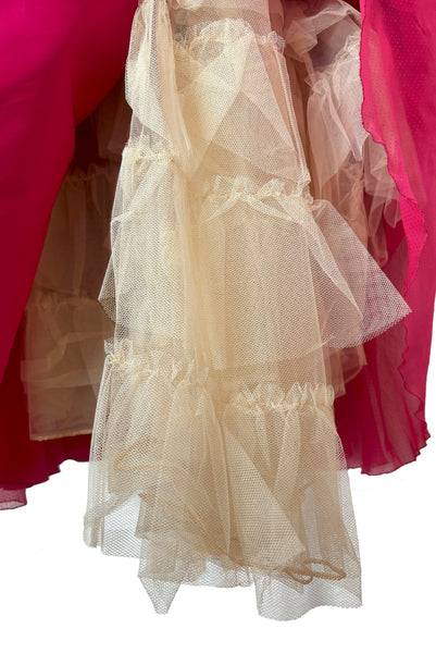Detail view of 1960s vintage hot pink iridescent glitter organza ruffled evening dress by Mike Benet, size extra extra small to extra small. Showing a close-up of the built-in ruffled tulle petticoat.