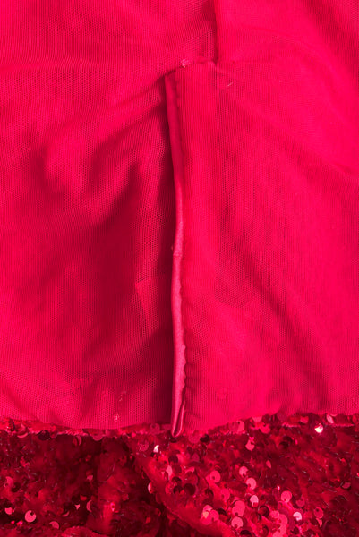 Interior detail view of red stretch velvet, sequin embellished dress with satin straps, sweetheart neckline, cold shoulder short sleeves, princess seamed bodice, and pencil skirt.  Showing the back of the satin trimmed kick pleat in the pencil skirt. 
