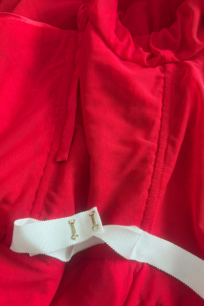 Interior detail view of red stretch velvet, sequin embellished dress with satin straps, sweetheart neckline, cold shoulder short sleeves, princess seamed bodice, and pencil skirt.  Showing the cream petersham ribbon waist stay with gold tone hooks. 