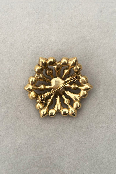 Vertical back view of 2000s vintage y2k autumnal brown, orange, green, and yellow rhinestone hexagonal brooch, by Liz Claiborne.