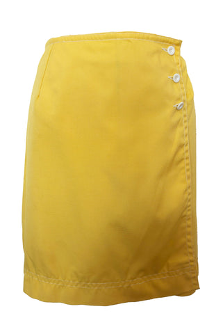 Front view of 1960s vintage Koret of California Koratron yellow fabric skort with white plastic buttons, size medium to large.