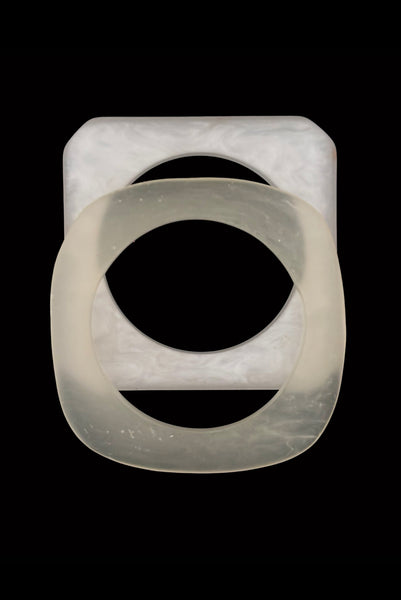 Vertical top view of 1980s vintage white matte frosted translucent marbled Lucite square bangle bracelet set of two (2).