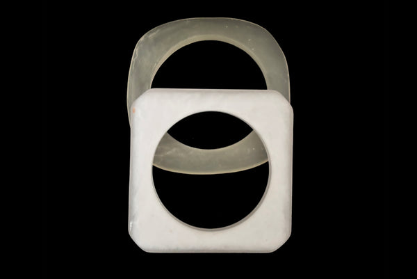 Horizontal bottom view of 1980s vintage white matte frosted translucent marbled Lucite square bangle bracelet set of two (2).