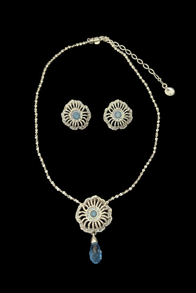 Vertical front view of early 2000s vintage silver tone, blue opaline rhinestone, and crystal floral adjustable necklace and pierced stud earrings jewelry set by Givenchy.
