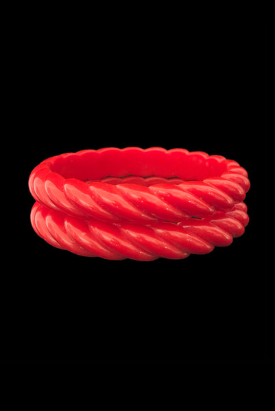 Vertical front view of 1980s vintage red rope plastic bangle bracelet set of two (2).