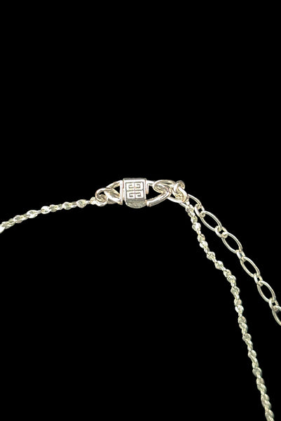 Detail view of early 2000s vintage silver tone, blue opaline rhinestone, and crystal floral adjustable necklace and pierced stud earrings jewelry set by Givenchy. Showing the clasp of the necklace marked with the Givenchy stamp.
