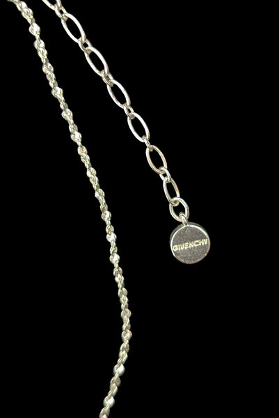 Detail view of early 2000s vintage silver tone, blue opaline rhinestone, and crystal floral adjustable necklace and pierced stud earrings jewelry set by Givenchy. Showing the end of the necklace stamped Givenchy.