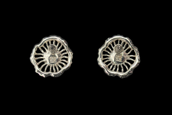 Earring back view of early 2000s vintage silver tone, blue opaline rhinestone, and crystal floral adjustable necklace and pierced stud earrings jewelry set by Givenchy. Showing the flower shaped silver tone earrings marked with the Givenchy stamp.