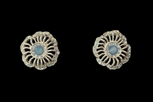 Earring front view of early 2000s vintage silver tone, blue opaline rhinestone, and crystal floral adjustable necklace and pierced stud earrings jewelry set by Givenchy. Showing the flower shaped silver tone earrings studded with blue opaline round rhinestones.