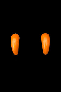 Vertical front view of 1930s vintage butterscotch French Bakelite half hoop clip-on earrings.