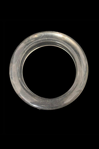 Vertical top view of 1980s vintage clear Lucite asymmetrical bangle bracelet.