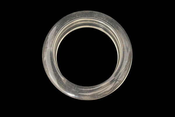 Horizontal bottom view of 1980s vintage clear Lucite asymmetrical bangle bracelet.