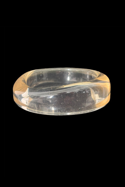 Vertical front view of 1980s vintage clear Lucite asymmetrical bangle bracelet.