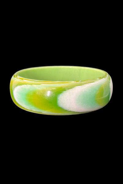 Vertical back view of 1960s vintage green, chartreuse, and white feathered Lucite plastic domed bangle bracelet.