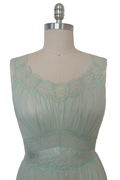 Bodice front view of 1940s vintage pale aqua blue lace, nylon, and satin ribbon ballerina nightgown by Vanity Fair, small to medium. Showing the scoop neck lace neckline, gathered bust, and lace and ribbon midriff.