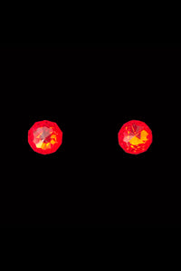 Vertical front view of 1930s vintage flame orange faceted glass round foil back screw back earrings.