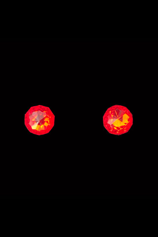 Vertical front view of 1930s vintage flame orange faceted glass round foil back screw back earrings.