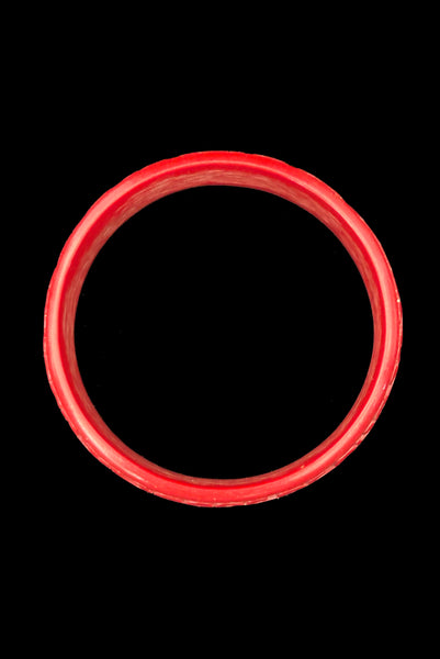 Vertical bottom view of 1950s vintage red cinnabar scroll carved lacquered Asian bangle bracelet.