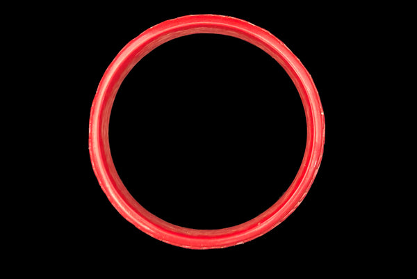 Horizontal bottom view of 1950s vintage red cinnabar scroll carved lacquered Asian bangle bracelet.