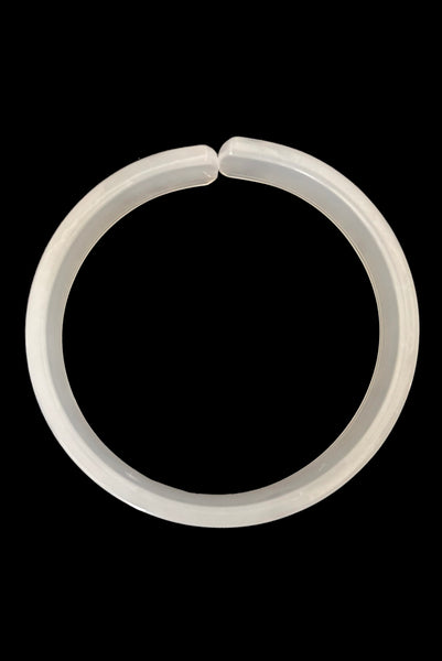 Vertical top view of 1950s vintage white moonglow Lucite plastic split sliced bangle bracelet.