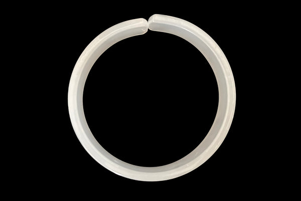 Horizontal top view of 1950s vintage white moonglow Lucite plastic split sliced bangle bracelet.