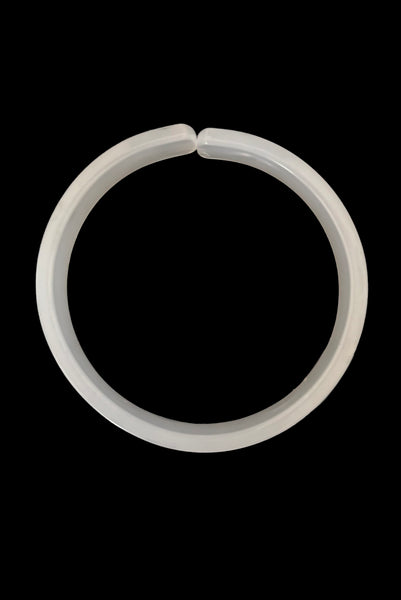 Vertical bottom view of 1950s vintage white moonglow Lucite plastic split sliced bangle bracelet.