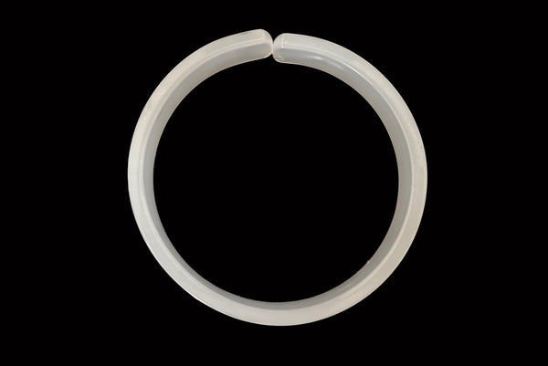Horizontal bottom view of 1950s vintage white moonglow Lucite plastic split sliced bangle bracelet.