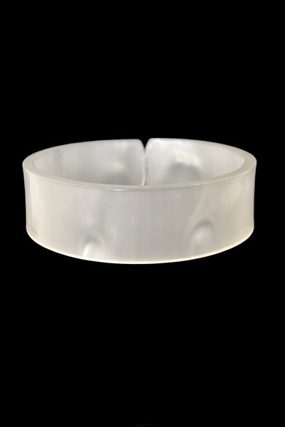 Vertical back view of 1950s vintage white moonglow Lucite plastic split sliced bangle bracelet.