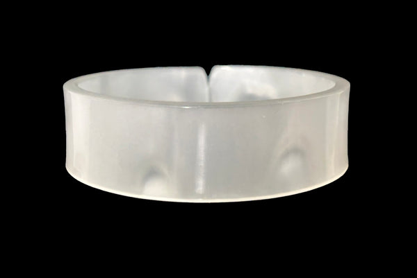 Horizontal back view of 1950s vintage white moonglow Lucite plastic split sliced bangle bracelet.