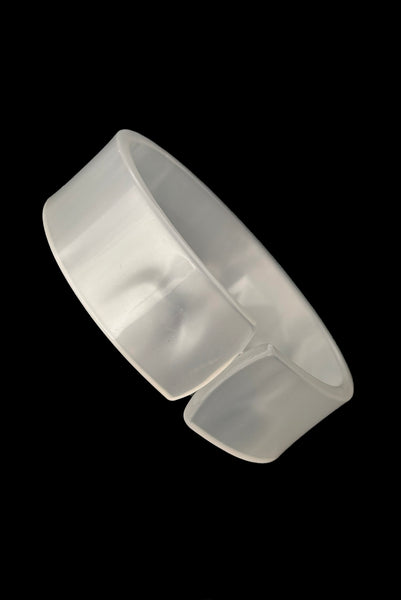 Vertical perspective view of 1950s vintage white moonglow Lucite plastic split sliced bangle bracelet.