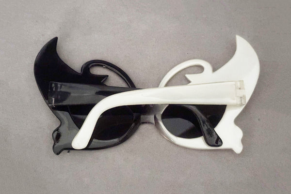 Horizontal back view of early 2000s y2k vintage black and white plastic butterfly/insect rhinestone effect retro sunglasses.