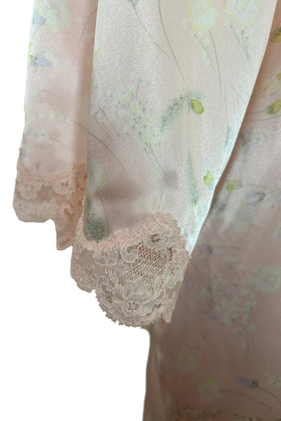 Sleeve detail view of 1980s vintage lace trimmed pink floral satin robe by Valentino Intimo, small, medium, large. Showing the pink lace trim at the cuffs.