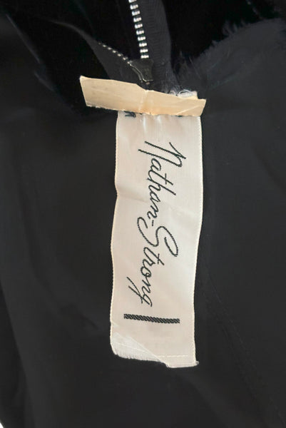 Interior detail view of 1950s vintage black silk satin and velvet wiggle cocktail dress, by Nathan Strong, extra small to small. Showing the  Nathan-Strong label.