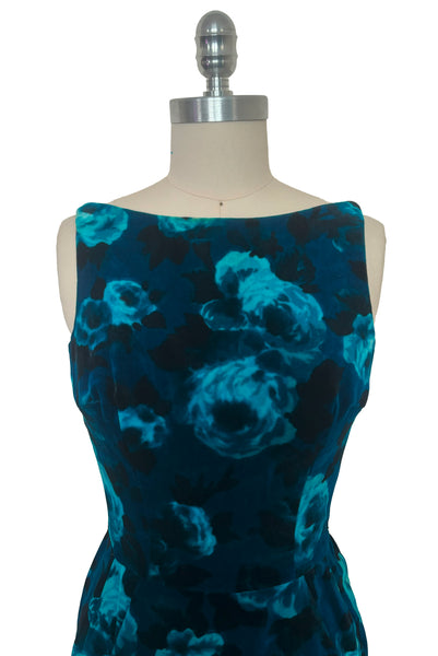 Dress bodice front view of 1950s vintage teal and turquoise blue floral velvet dress and jacket set by Lillie Rubin, size extra small to small. Showing the boat neck, sleeveless sheath silhouette with pencil skirt.