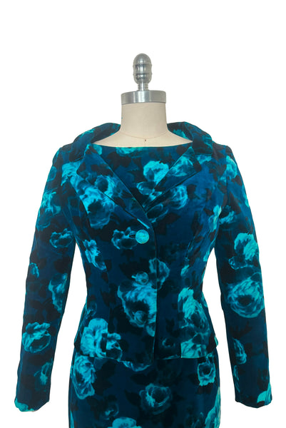 Jacket front view of 1950s vintage teal and turquoise blue floral velvet dress and jacket set by Lillie Rubin, size extra small to small. Showing the standing collar, self fabric covered buttons, long sleeves, and slim pencil silhouette.