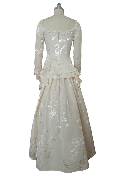 Back view of 1990s vintage cream jacquard & lace pointed sweetheart neckline, long sleeve, bustle back wedding dress by Jessica McClintock, extra small to small.