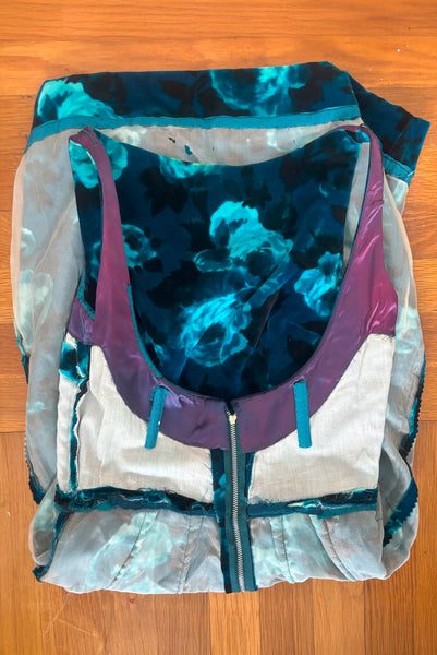 Interior detail view of 1950s vintage teal and turquoise blue floral velvet dress and jacket set by Lillie Rubin, size extra small to small. Showing fading to the blue satin facing, metal zipper, and boning to reinforce the low back of the dress.