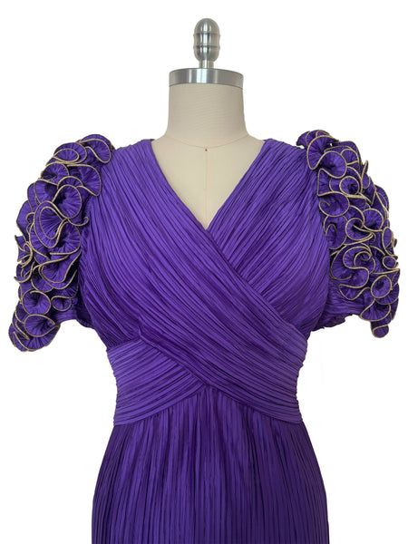 Bodice front view of 1980s vintage purple peated satin dress with purple and gold ruffled statement sleeves by Richilene, size medium to large.