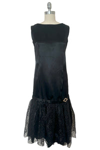 Front view of 1960s does 1920s vintage black satin and lace flapper dress costume, small to medium.