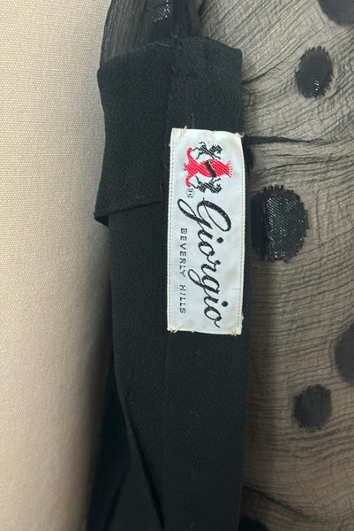 Interior detail view of 1990s vintage black polka dot silk chiffon and crepe asymmetrical dress by Giorgio Beverly Hills, size small to medium. Showing the Giorgio Beverly Hills label.