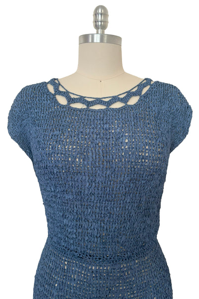 Bodice front view of 1950s vintage periwinkle rayon ribbon crochet dress, medium to extra large. Showing the cut out, scalloped, scoop neckline, cap sleeves, and elastic waist. 