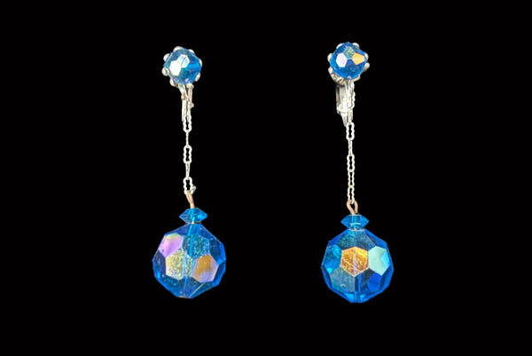 Horizontal front view of 1960s vintage blue iridescent crystal and silver chain link top and drop clip on earrings for unpierced ears.