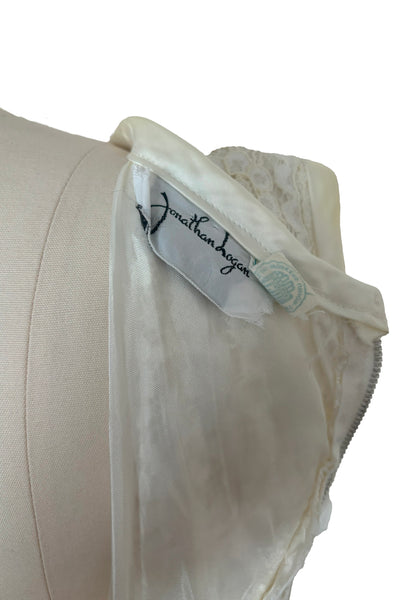 Interior detail view of 1960s vintage white corded lace sleeveless sheath dress by Jonathan Logan, size small to medium. Showing the Jonathan Logan and Union labels.