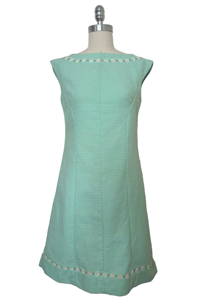 Front view of 1960s vintage mint green cotton pique daisy trimmed sheath dress, size extra small to small.