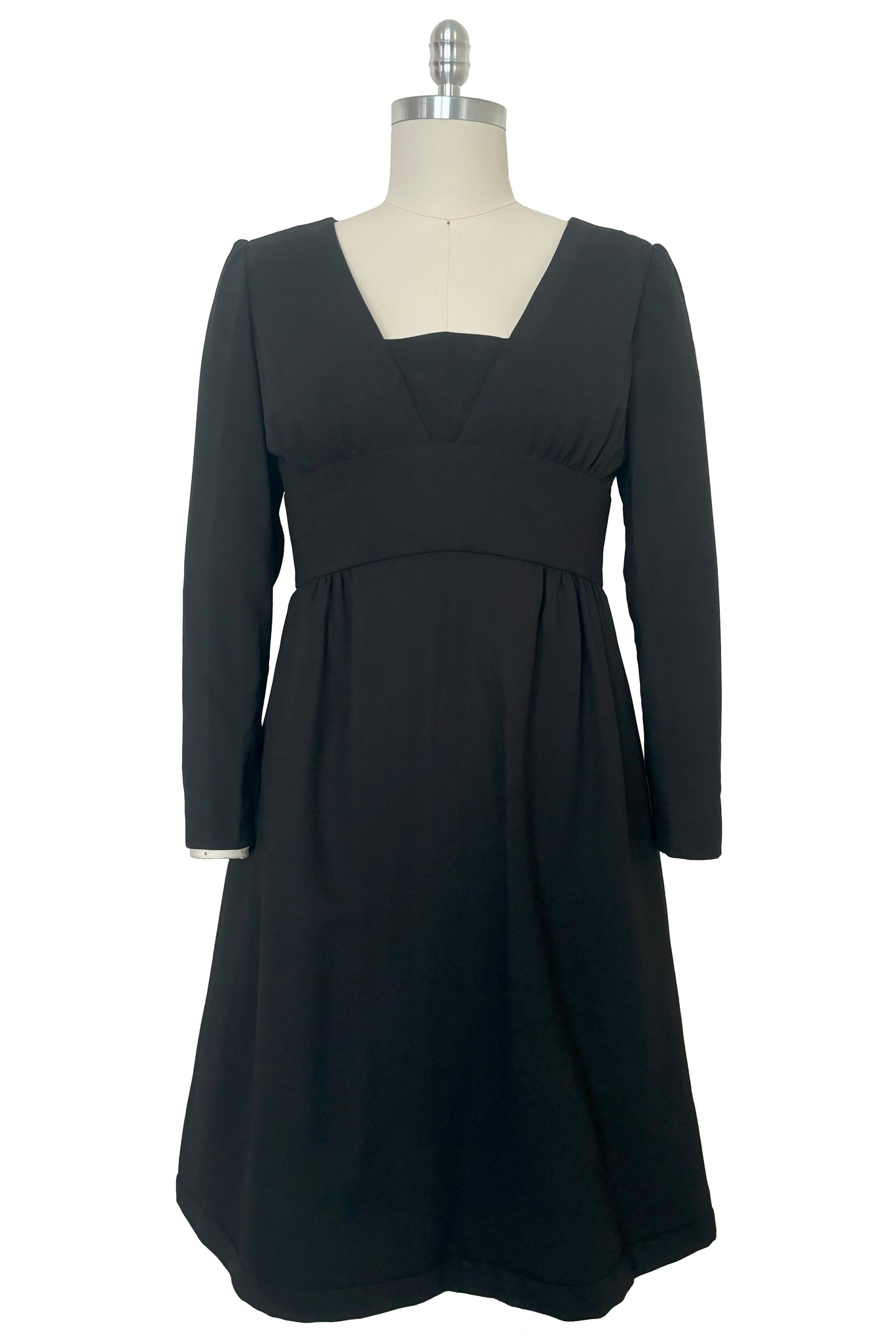 Front view of 1960s vintage Mod crepe empire waist little black dress, by Teal Traina, size small to medium.